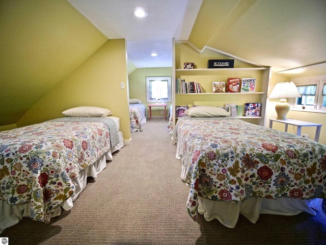 carpeted bedroom with multiple windows and lofted ceiling
