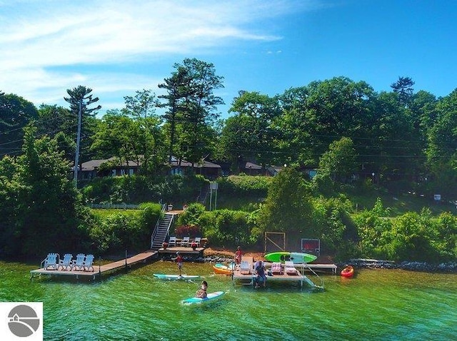 view of home's community featuring a lawn and a water view