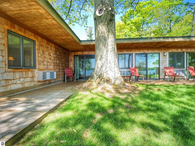 back of property with a lawn and a patio area