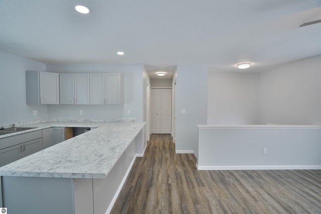 kitchen with dark hardwood / wood-style flooring, gray cabinets, a kitchen island, and sink