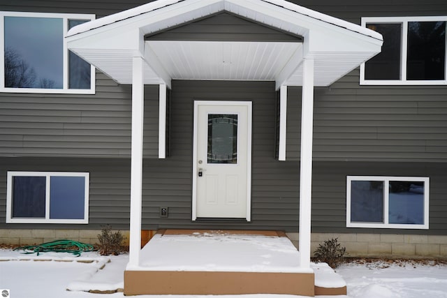 view of snow covered property entrance