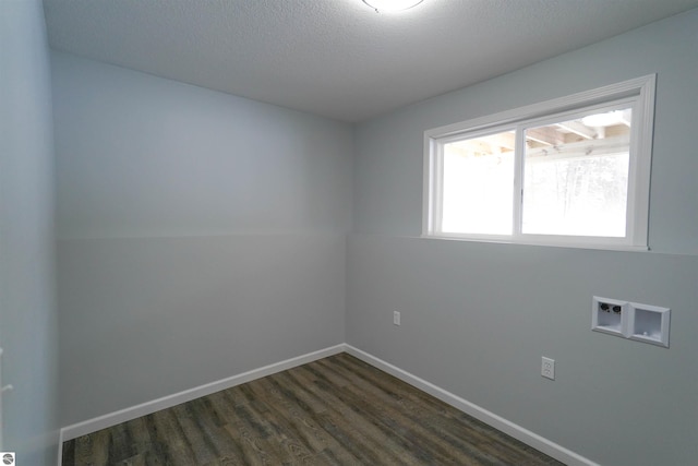 spare room with dark hardwood / wood-style floors and a textured ceiling