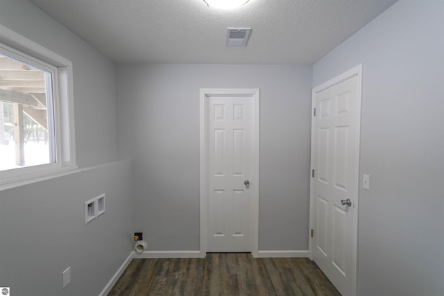 laundry area featuring dark hardwood / wood-style flooring, hookup for a washing machine, and a textured ceiling