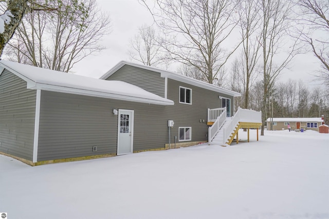 view of snow covered back of property