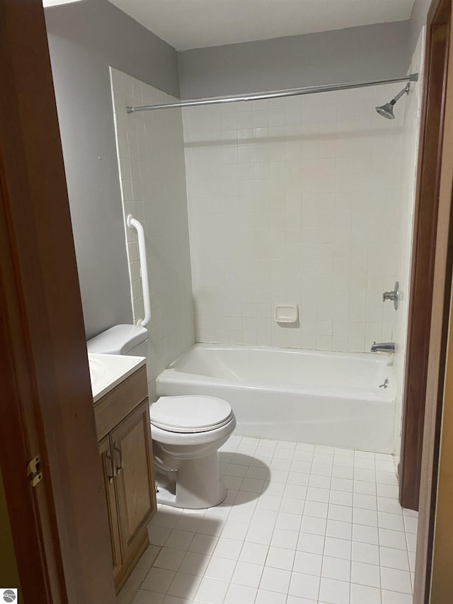 full bathroom with tile patterned flooring, vanity, toilet, and tiled shower / bath