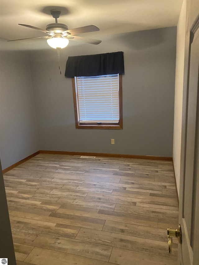 spare room with ceiling fan and light hardwood / wood-style floors