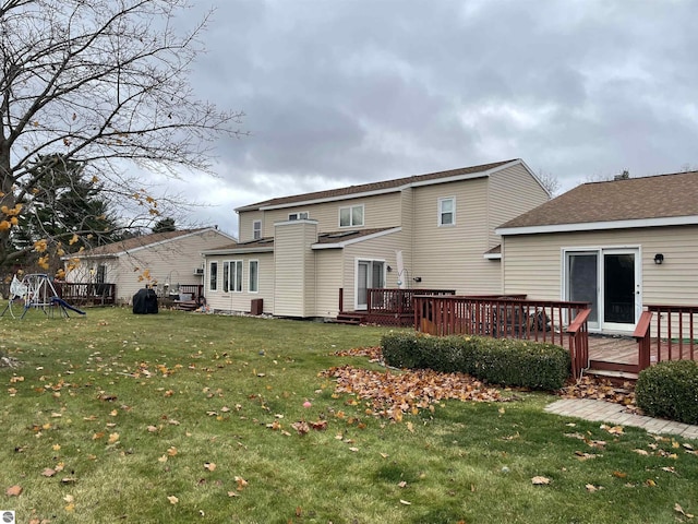 back of house with a yard and a deck