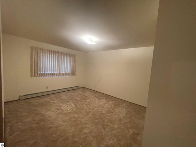 empty room featuring carpet floors and a baseboard radiator