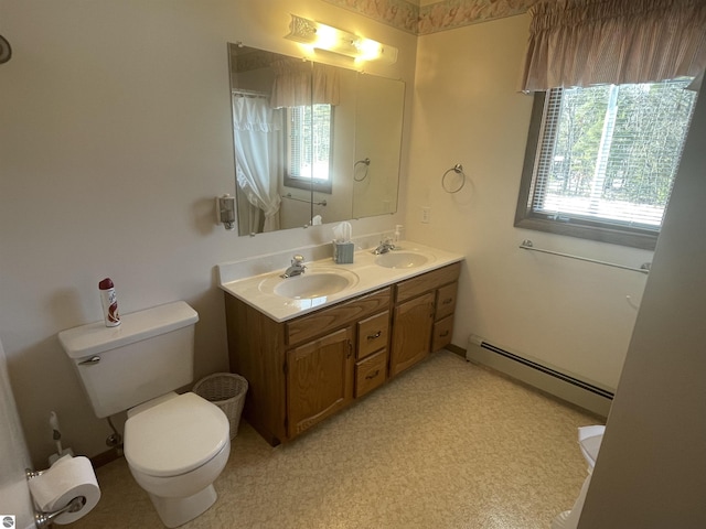 bathroom featuring baseboard heating, vanity, and toilet