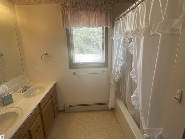 bathroom featuring baseboard heating, shower / bathtub combination with curtain, and vanity