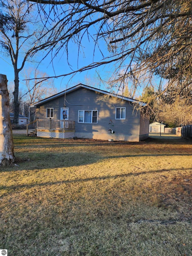 exterior space featuring a deck and a front lawn