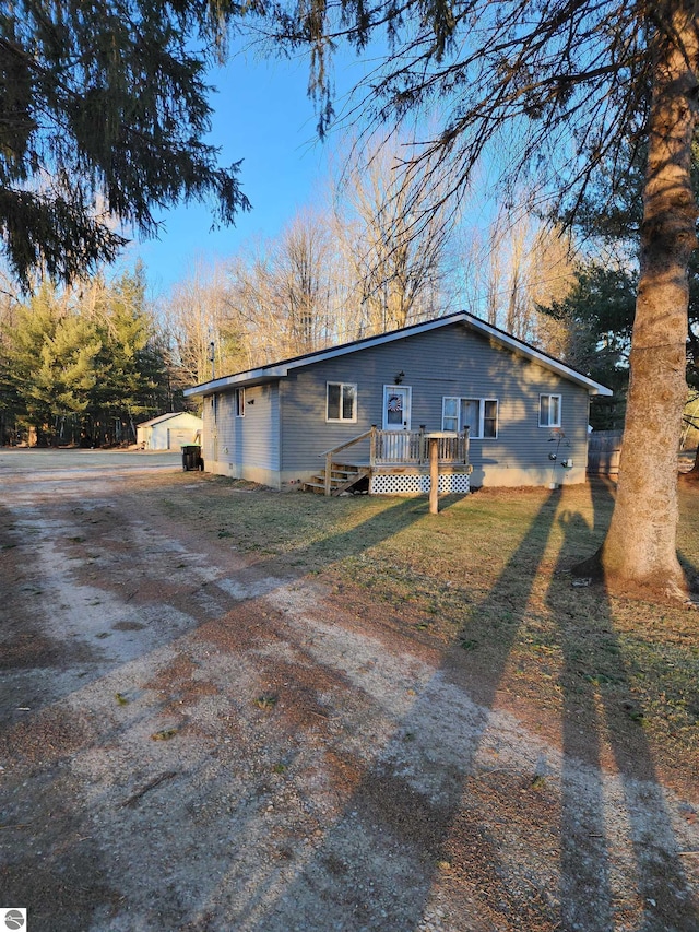 exterior space with a front yard and a wooden deck