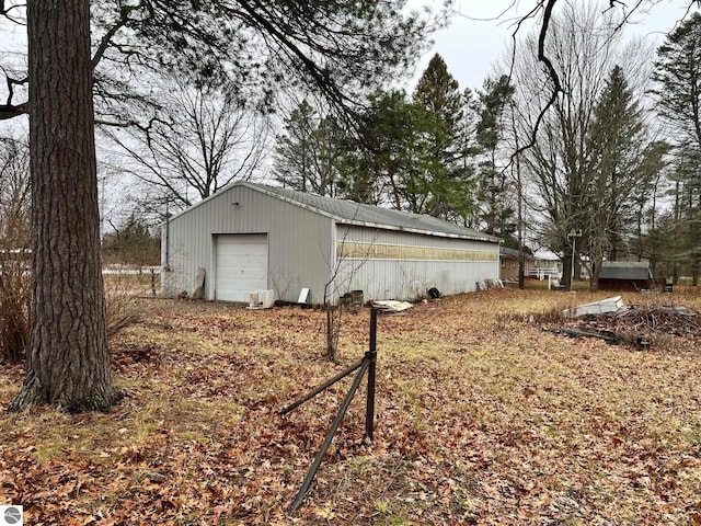 exterior space with an outbuilding and a garage