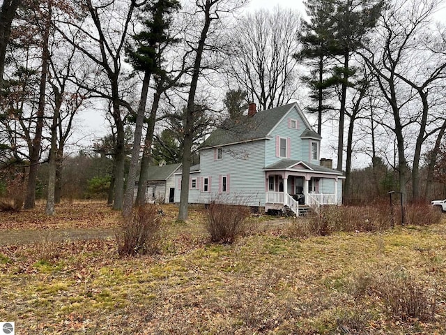 view of side of property featuring a porch