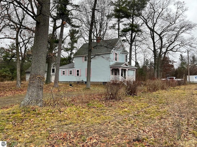 view of side of property with covered porch