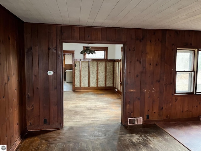 hallway featuring wooden walls and hardwood / wood-style floors