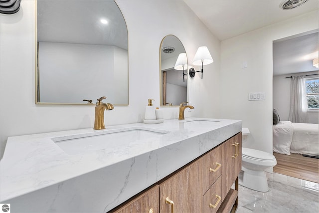 bathroom with toilet and vanity