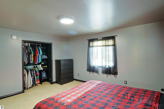 bedroom with a closet and light colored carpet