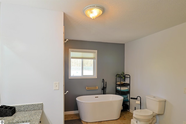 bathroom with a bathing tub, vanity, toilet, and tile patterned floors