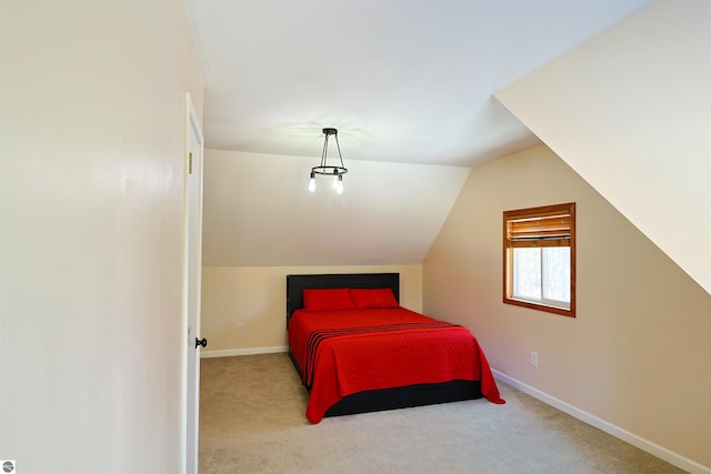 carpeted bedroom featuring lofted ceiling