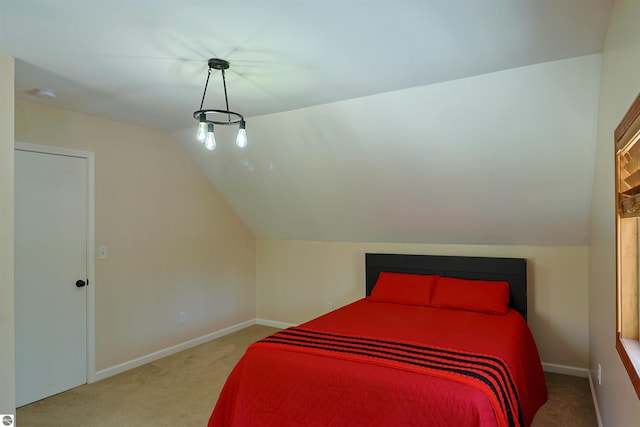 carpeted bedroom featuring vaulted ceiling