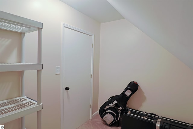 interior space featuring carpet flooring and lofted ceiling