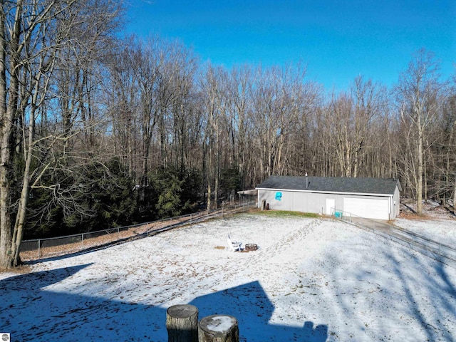 yard layered in snow with an outdoor structure