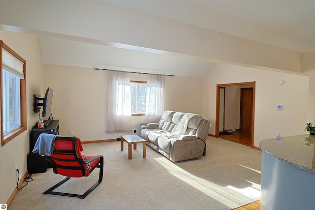 carpeted living room featuring lofted ceiling