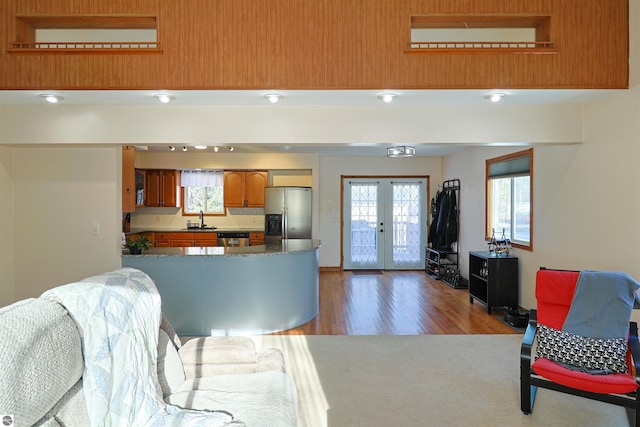 kitchen with appliances with stainless steel finishes, french doors, dark wood-type flooring, and sink