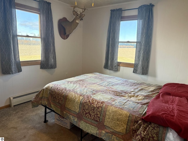 bedroom featuring carpet, ornamental molding, multiple windows, and a baseboard heating unit