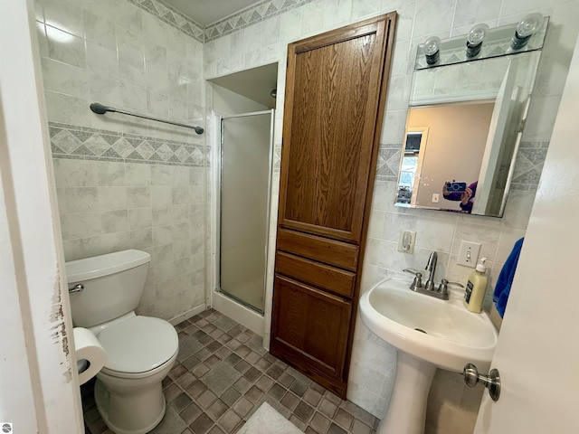 bathroom featuring decorative backsplash, toilet, tile walls, and walk in shower