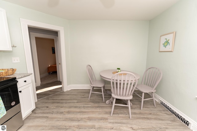 dining area with light hardwood / wood-style floors