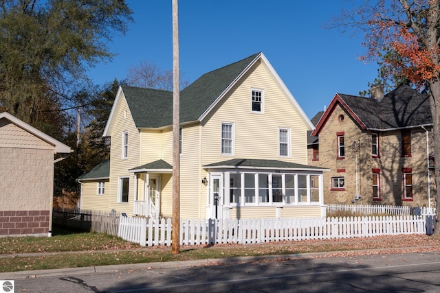 view of front of property featuring a sunroom