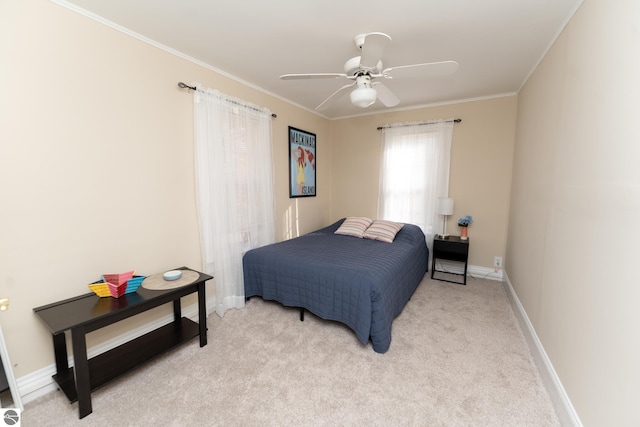 bedroom with ceiling fan, light carpet, and ornamental molding