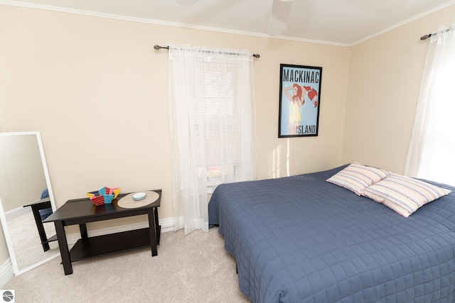 bedroom featuring light carpet, multiple windows, ceiling fan, and ornamental molding