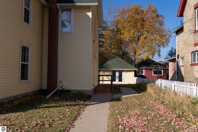 exterior space featuring a lawn and an outdoor structure