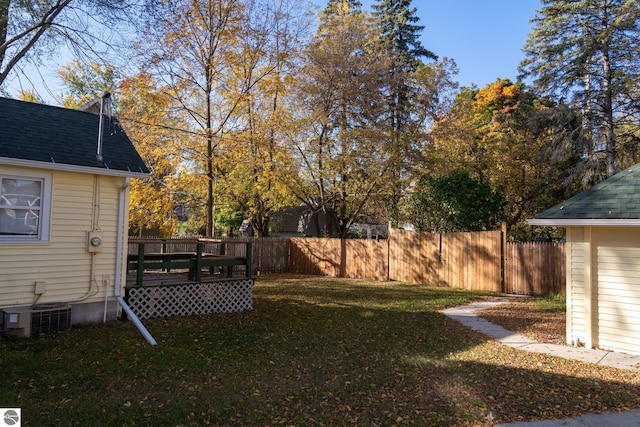 view of yard with cooling unit and a deck