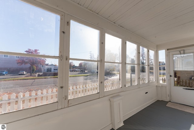 unfurnished sunroom featuring wooden ceiling and a healthy amount of sunlight