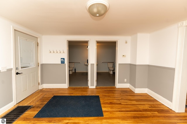 hallway with hardwood / wood-style flooring