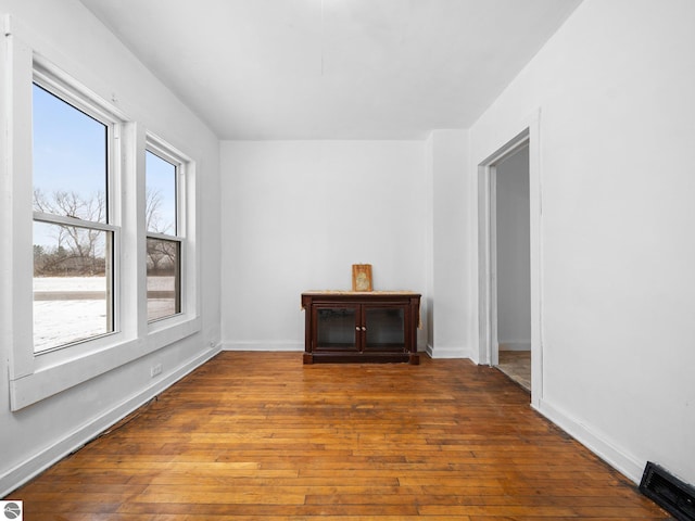 unfurnished room with dark wood-type flooring