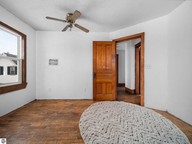 bedroom with ceiling fan and dark hardwood / wood-style floors