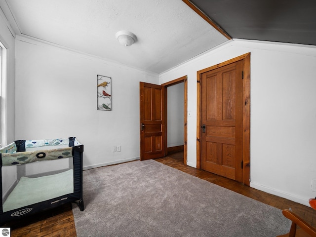 bedroom with dark wood-type flooring and lofted ceiling