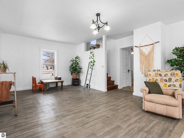 living area with wood-type flooring and a chandelier