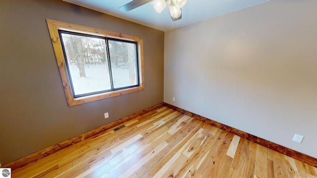 108 Rolling Oak Ln, Roscommon, MI 48653 - empty room with baseboards, light wood-style flooring, visible vents, and a ceiling fan