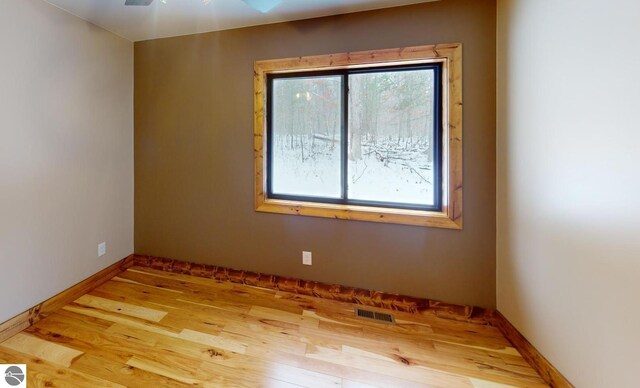 108 Rolling Oak Ln, Roscommon, MI 48653 - unfurnished room featuring baseboards, visible vents, and wood finished floors