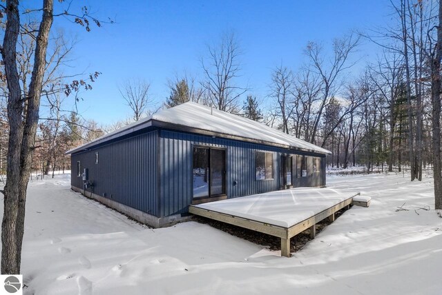 108 Rolling Oak Ln, Roscommon, MI 48653 - snow covered back of property with a wooden deck