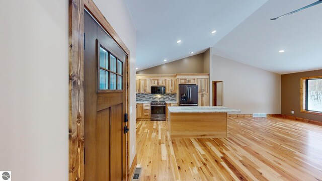 108 Rolling Oak Ln, Roscommon, MI 48653 - kitchen featuring light countertops, refrigerator with ice dispenser, backsplash, black microwave, and electric stove