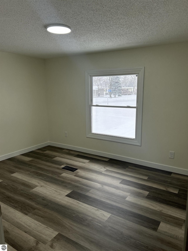 unfurnished room featuring dark hardwood / wood-style floors