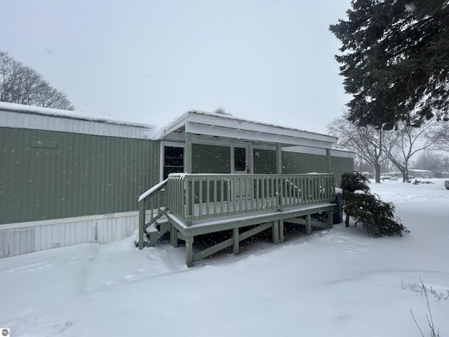 snow covered property featuring a deck