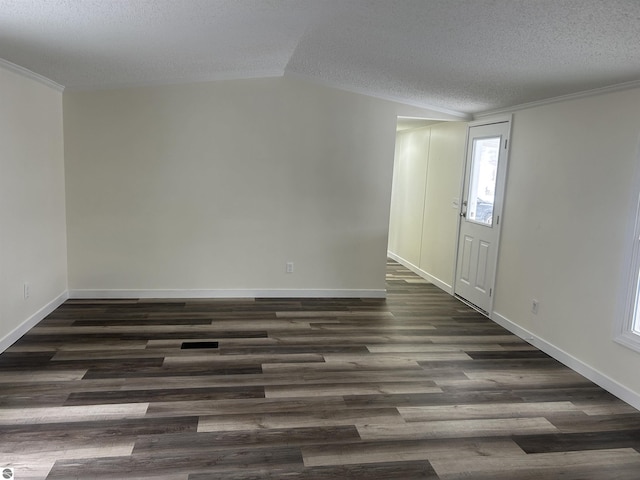 interior space featuring dark hardwood / wood-style floors, crown molding, lofted ceiling, and a textured ceiling